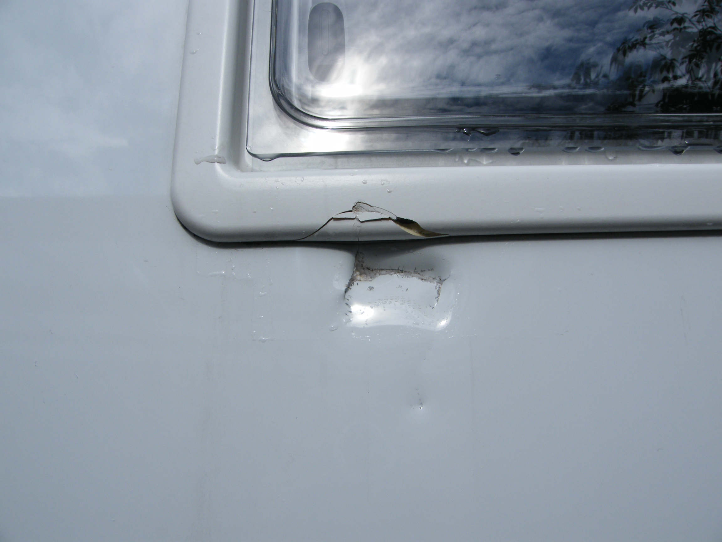 3 - Cracked window frame & bodywork dents 2.JPG